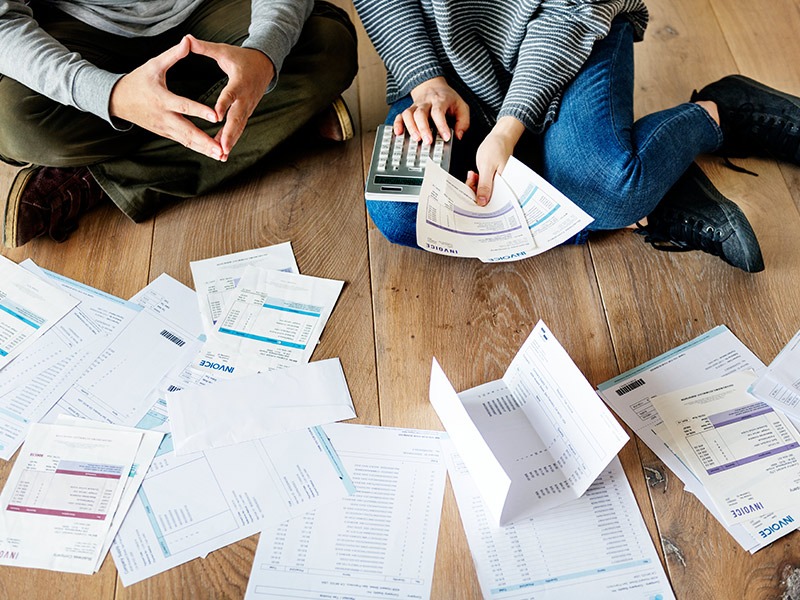 a couple using a calculator to organize their debts chicago il